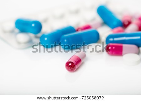 Lots of colorful drugs and pills. Capsules closeup. Shows the contents of the capsules