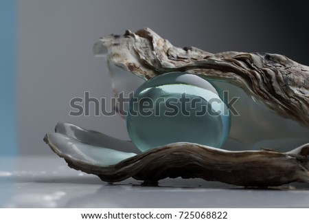 blue Hydrogel in the shell. A huge transparent blue ball inside an oyster, close-up. A symbolic picture of growing a large sphere like water inside an oyster