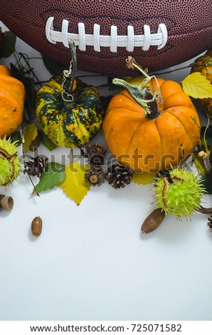 The ball for football with pumpkins, three leaves, acorn and cones on the white background. The picture is awesome for fall football game invitation card.