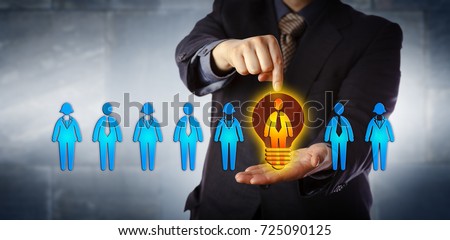 Unrecognizable manager appointing the ideal candidate from a lineup of four male and four female workers. Business concept for talent acquisition, coaching, promotion and performance evaluation. Royalty-Free Stock Photo #725090125