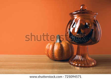 pumpkin with cup pot of candy in halloween concept