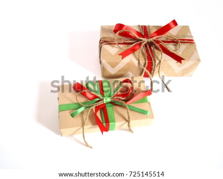 A festive gift. A lot of boxes with gifts. A Christmas gift. New Year's surprise. Gift in the box. Ribbon, bow and paper. Colors red kraft, brown, green. White background.