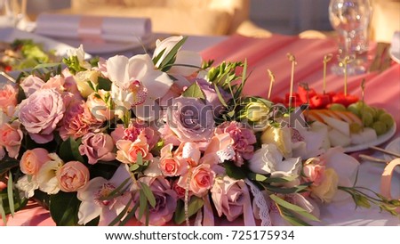 Wedding bouquet of roses. Bride's bouquet on wedding day. Bouquet of different flowers. Bouquet of beautiful pink and white or red roses on the dressing stool. Roses