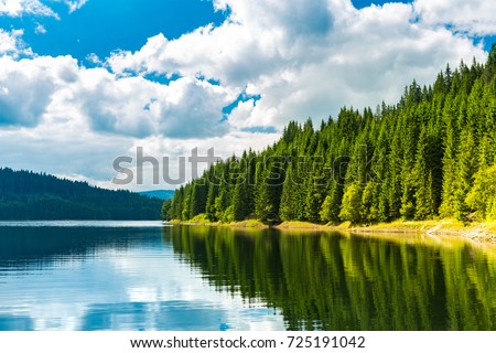 Vidra dam lake. Vidra Lake is a storage reservoir, located in the Parang Mountains, on the Lotru River, in Valcea County, Romania. Royalty-Free Stock Photo #725191042