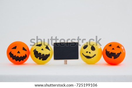 Self Made Hand Drawn Smiley Face Halloween Pumpkin Ball in Yellow and orange on white wall with copy space