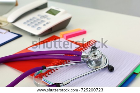 Medical stethoscope and a plate on the table