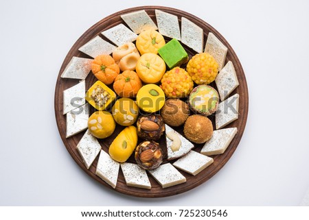 Stock photo of Indian sweets served in silver or wooden plate. variety of Peda, burfi, laddu in decorative plate, selective focus Royalty-Free Stock Photo #725230546