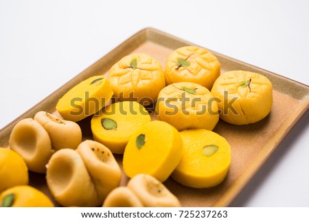 stock photo of collection of variety of sweets or orange peda or pedha or pera made up of milk, khoya, sugar , saffron etc. selective focus