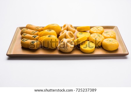 stock photo of collection of variety of sweets or orange peda or pedha or pera made up of milk, khoya, sugar , saffron etc. selective focus
