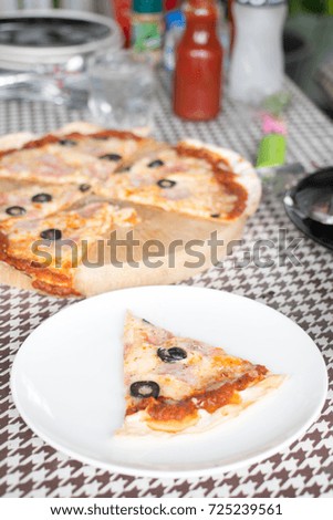 Italian pizza with ham olives and mushrooms