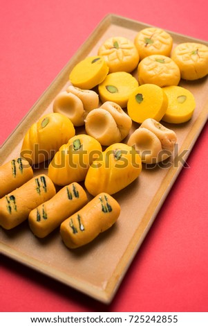 stock photo of collection of variety of sweets or orange peda or pedha or pera made up of milk, khoya, sugar , saffron etc. selective focus

