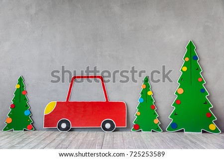 Cardboard car and Christmas tree. Xmas holiday concept