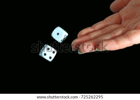 Female Hand Throwing Dice On Black Background