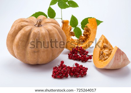 fresh pumpkin with slices and daisies on a white background