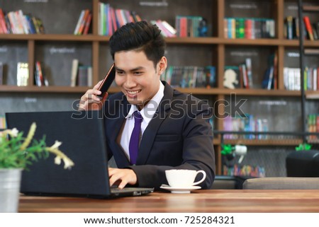 Working remotely, Businessman is sitting and talking on the phone with a smiling face. (selective focus,out of focus) Royalty-Free Stock Photo #725284321