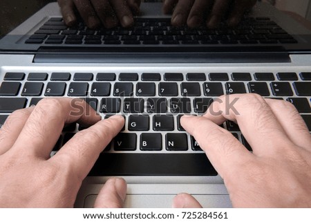 Using laptop computer ,  Hand typing on laptop keyboard