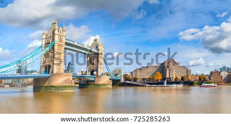 Tower Bridge in London, England, on a bright sunny day under gorgeous sky with clouds. Panoramic image.
