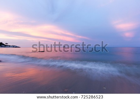 wave bounce the beach and twilight sky in evening  time with sand in nature, slow speed shutter