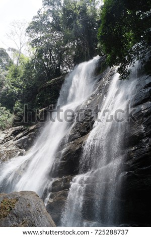 waterfall over stones in the jungle