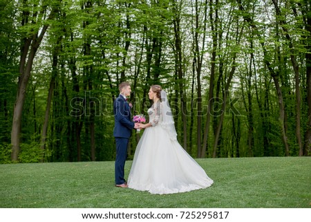 bride with the groom on the green glade