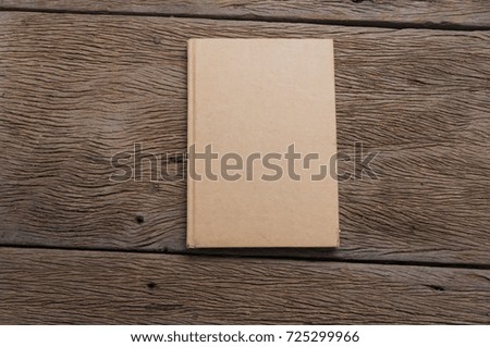 brown notebook on wood table