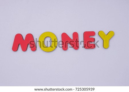 Word Money from wooden letters on light grey background