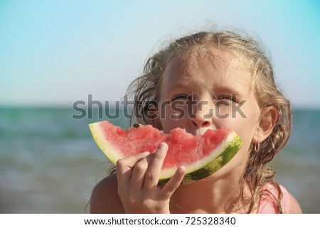 girl with a watermelon on the background of the sea