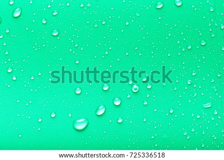 Drops of water on a color background. Green. Toned.