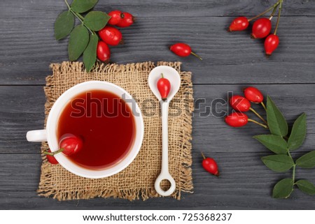 tea with rose hips on black wooden background. Top view
