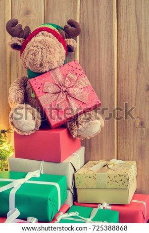 gifts and toys on wooden boards with Christmas holidays and happy smile kids.
