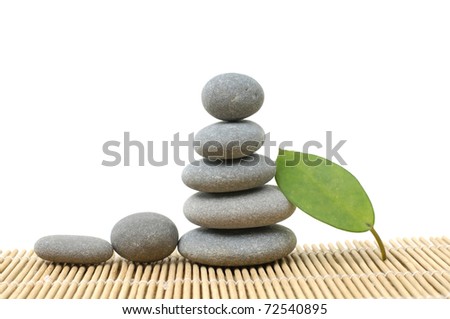 Stone tower with Green leaf on bamboo stick straw mat