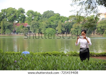 Young woman taking photos in Hanoi