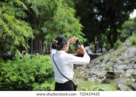 Young woman taking photos in Hanoi