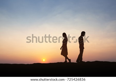 Silhouettes of couple man and woman  broken heart. In nature sunset. Love concept. Royalty-Free Stock Photo #725426836