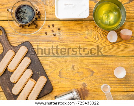 Image on top of table with savoyardi cookies, coffee