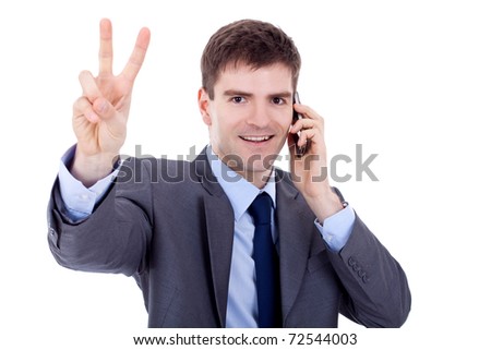young business man on the phone making his victory sign