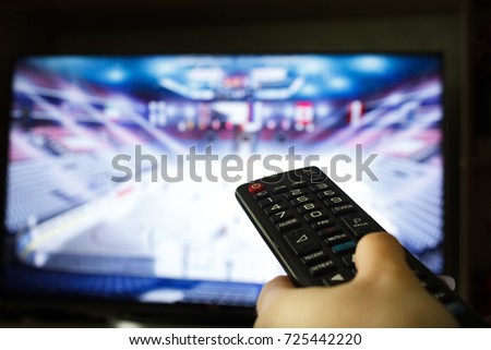 Football match and remote control Royalty-Free Stock Photo #725442220