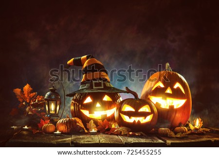Candle lit Halloween pumpkins Royalty-Free Stock Photo #725455255