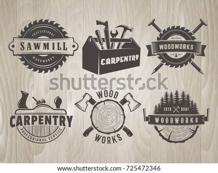 Woodwork logos. Vector badges for carpentry, sawmill, lumberjack service or woodwork shop. Set of hand tools labels on vintage wooden background. Royalty-Free Stock Photo #725472346