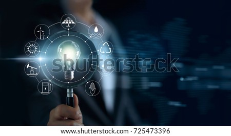 Man holding magnifying glass and light bulb ,search of global show the world's consumption with icons energy sources for renewable, sustainable development. Ecology concept
 Royalty-Free Stock Photo #725473396