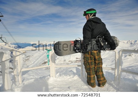 happy young man have fan while relaxing at snow with ski and snowboard sport at winter season