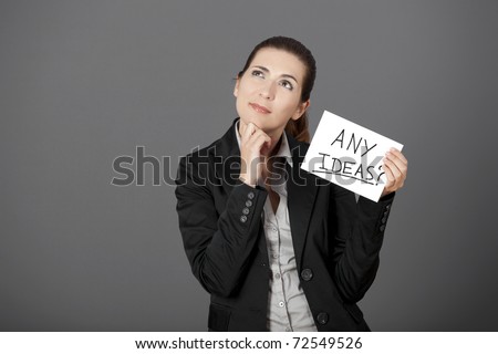 Business woman holding a card board with the text message "Any Ideas"
