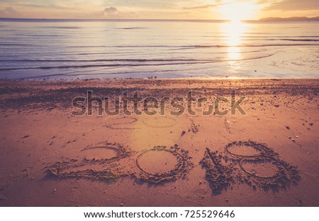 New Year 2018 is coming concept - inscription 2018 on a beach sand