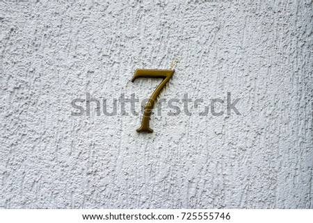 number 7 House number on the wall seven (7)