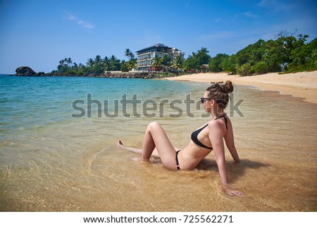 beautiful woman sunbathes on a beach, Sri Lanka