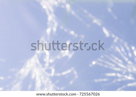 many white cracks on a blue mobile phone glass, blur abstract background