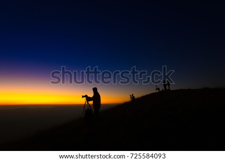 Silhouette of photographers happy twilight. Photographer with camera is ready to take sunrise pictures at Doi Mon Jong Chiang Mai Thailand.