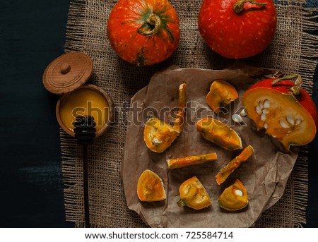 slices of pumpkin with honey on paper, on sacking texture, top view, free space for text, natural light