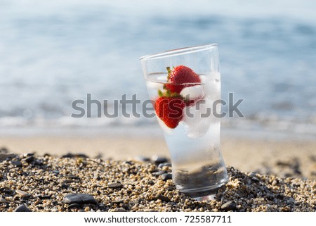 Frozen strawberry and pure water at the edge of the sea. 