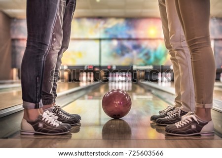 Cropped image of young friends playing bowling together